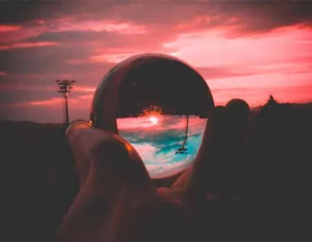 Crystal Ball Reflecting Sunset and Swing Over Ocean